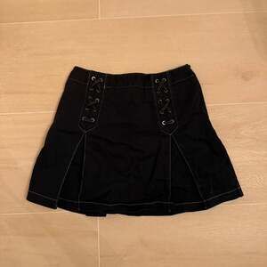 Matsumi black denim mini skort with lace-up detail